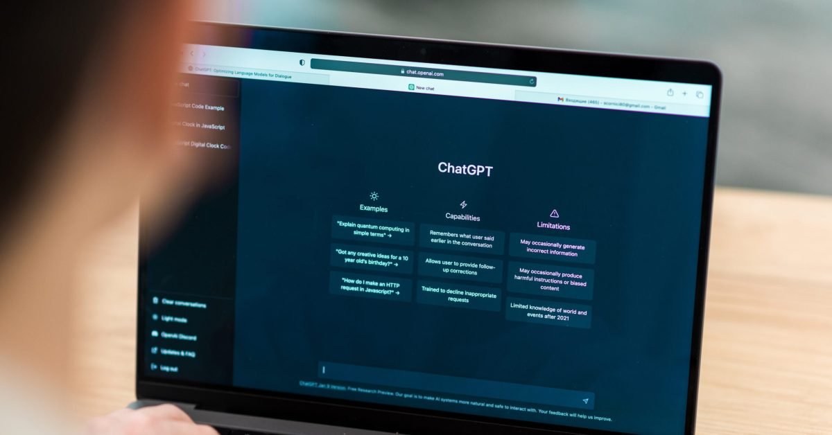 Close view of a man with opened AI chat on laptop